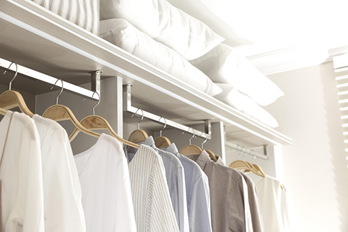 walk in closet with hanging clothes